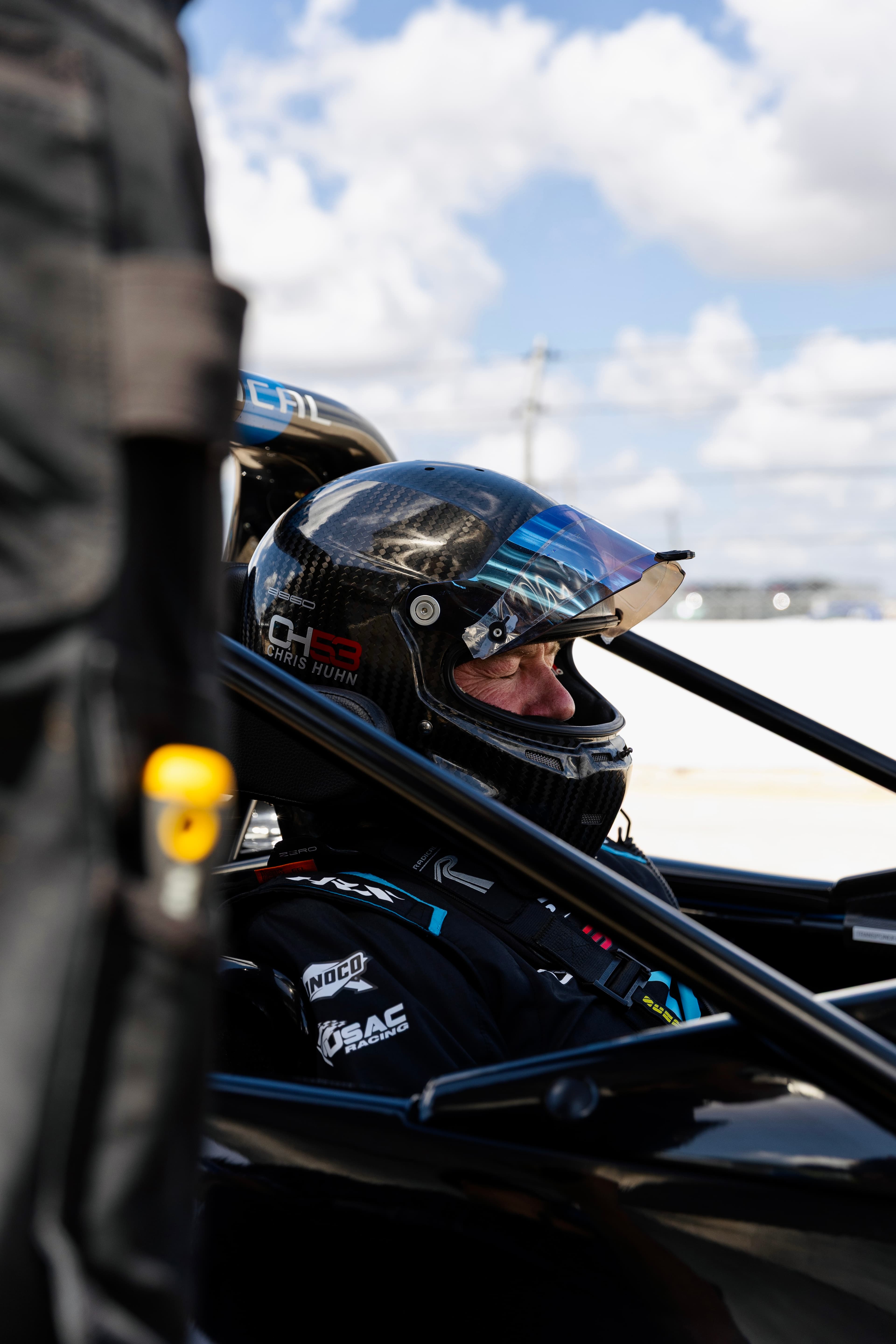 Driver in Radical helmet — focused instruction